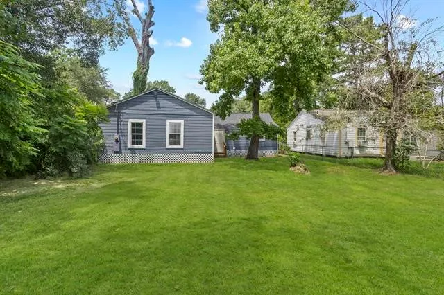 a front view of a house with yard and green space