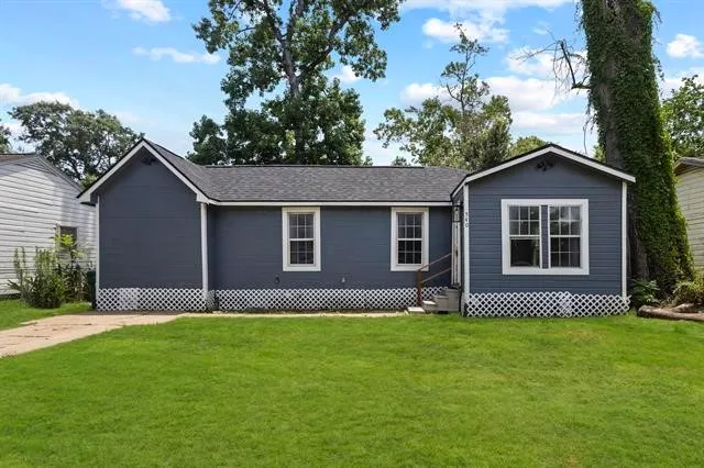 a front view of house with yard and green space
