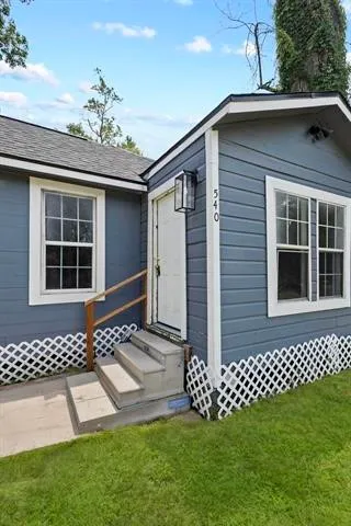 a front view of a house with a garden