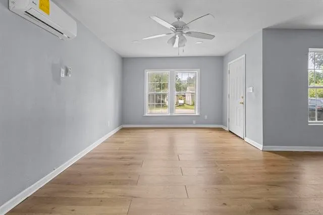 wooden floor in an empty room with a window