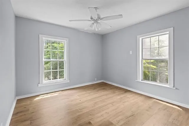 an empty room with windows and closet