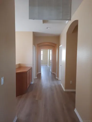 a view of gallery with wooden floor