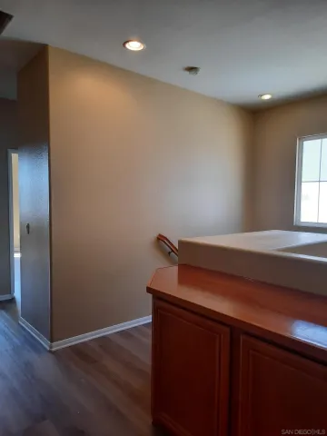 a room with a sink and wooden floor