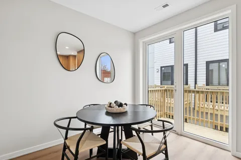 a view of a dining room with furniture and a window