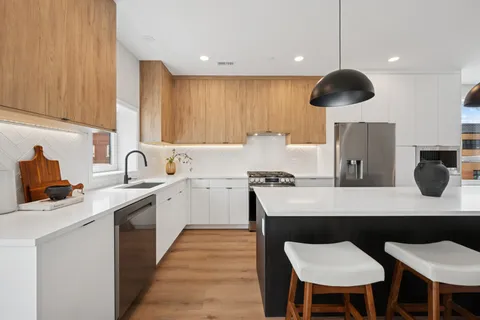 a kitchen with a sink cabinets and window