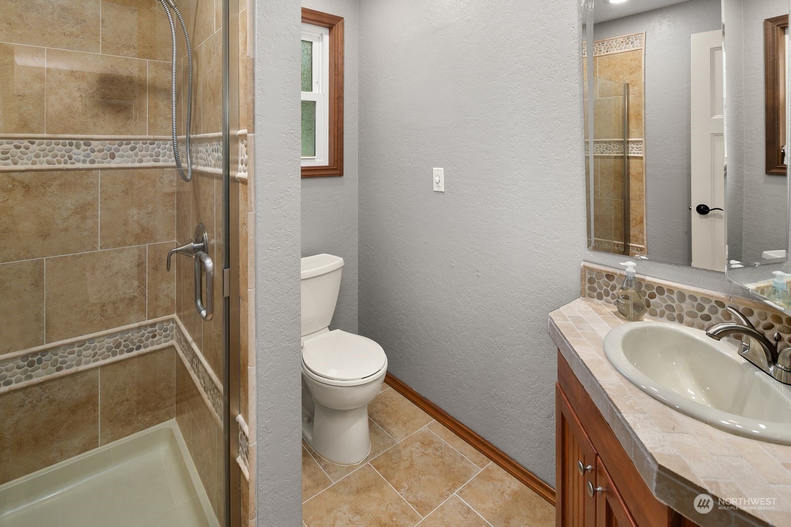 23211 3rd Avenue Southeast Bothell, WA 98021 - Photo 17 of 40 a bathroom with a sink a toilet and shower