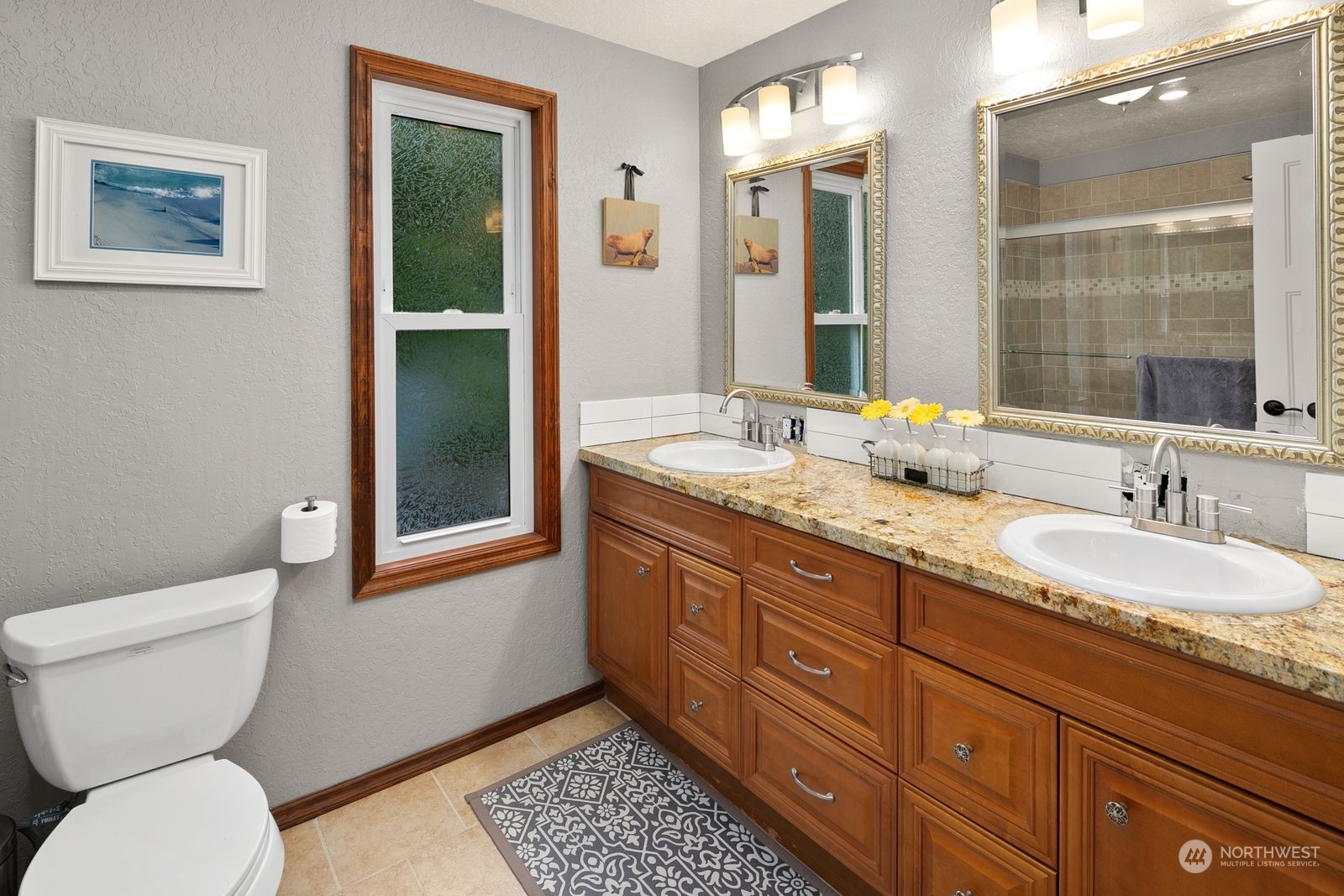 23211 3rd Avenue Southeast Bothell, WA 98021 - Photo 20 of 40 a bathroom with a granite countertop toilet and a sink
