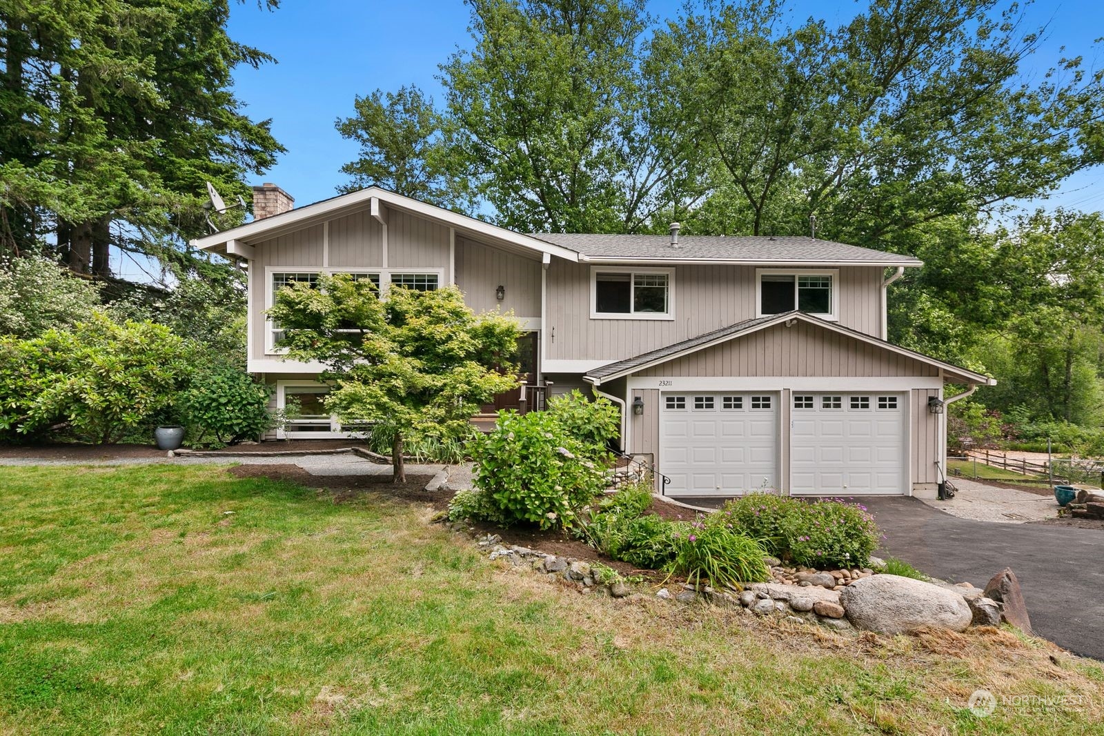 23211 3rd Avenue Southeast Bothell, WA 98021 - Photo 4 of 40 a front view of a house with a yard and garage