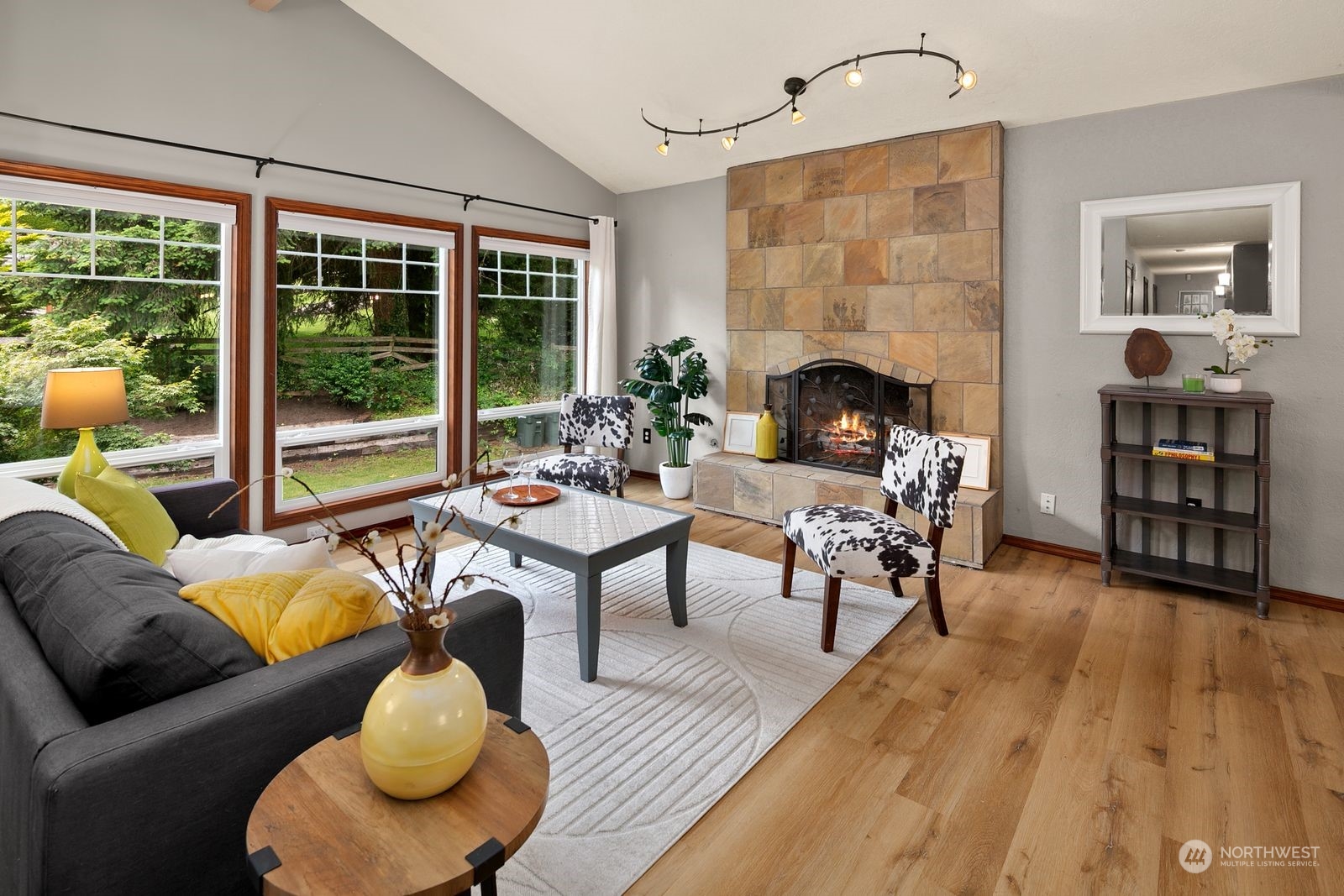 23211 3rd Avenue Southeast Bothell, WA 98021 - Photo 7 of 40 a living room with furniture a fireplace and a floor to ceiling window