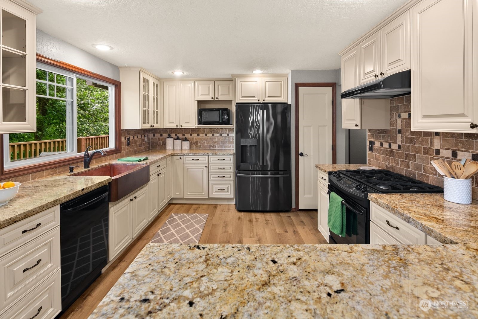 23211 3rd Avenue Southeast Bothell, WA 98021 - Photo 10 of 40 a large kitchen with stainless steel appliances granite countertop a stove a sink dishwasher a refrigerator and a oven with wooden floor