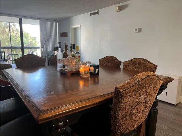 a bedroom with a bed and a lamp on dresser