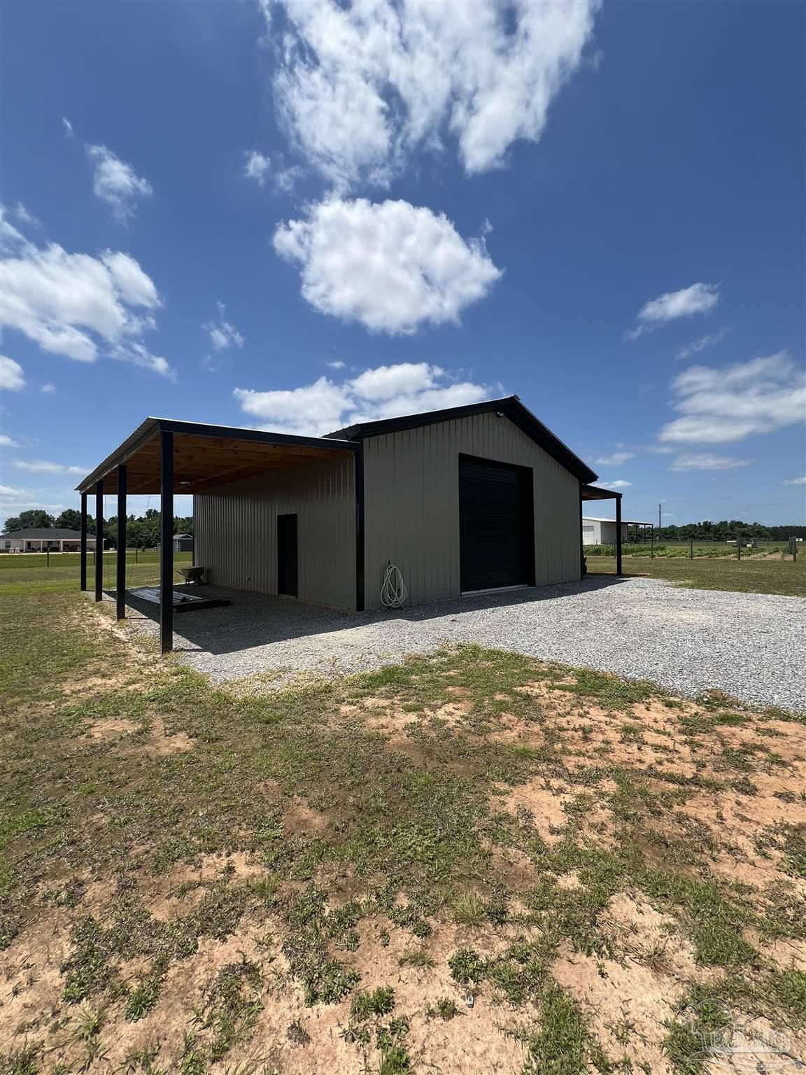 2351 Harvest Road Jay, FL 32565 - Photo 13 of 14 a backyard of a house with table and chairs