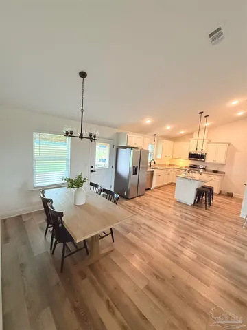 a outdoor kitchen with a table and chairs