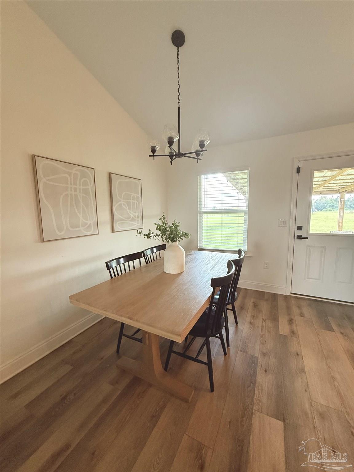 2351 Harvest Road Jay, FL 32565 - Photo 6 of 14 a view of a dining room with furniture window and wooden floor