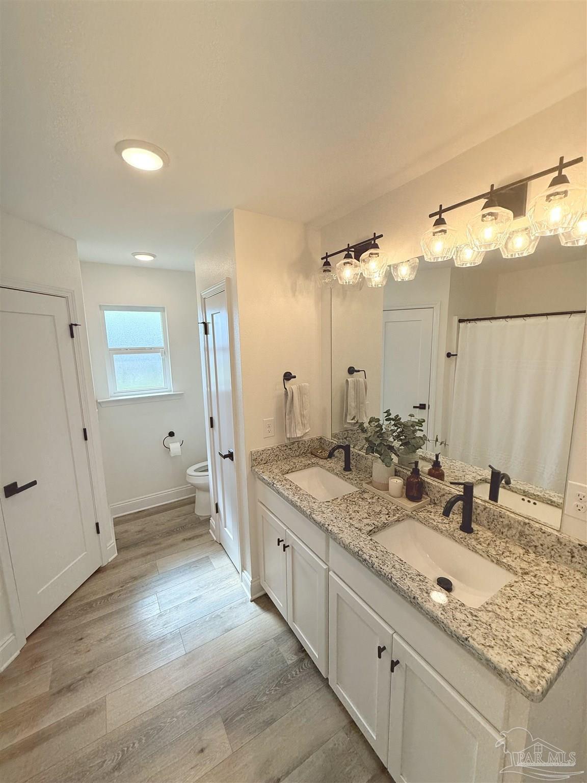 2351 Harvest Road Jay, FL 32565 - Photo 7 of 14 a bathroom with a granite countertop double vanity sink and mirror