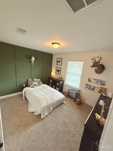 a bedroom with a bed and a dresser
