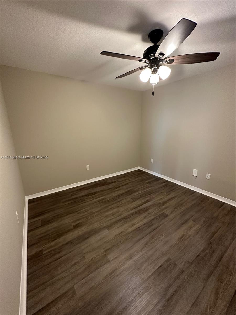 218 Northwest 12th Avenue, Unit 905 Miami, FL 33128 - Photo 11 of 15 a view of an empty room with wooden floor