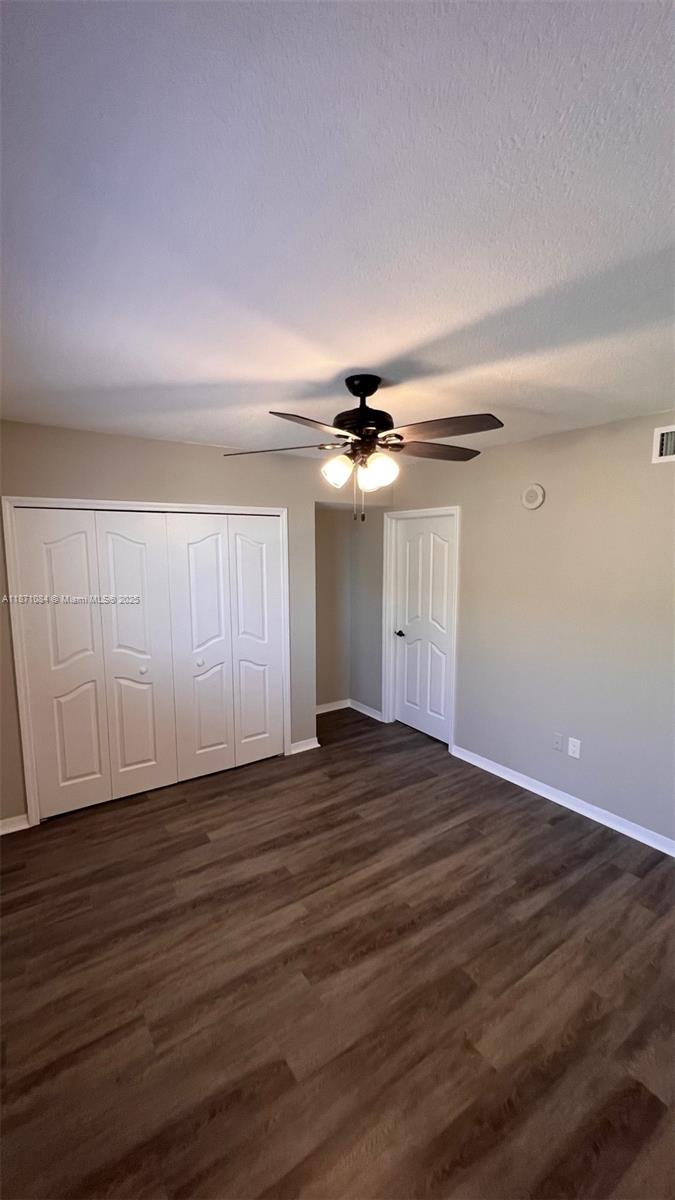 218 Northwest 12th Avenue, Unit 905 Miami, FL 33128 - Photo 10 of 15 a view of empty room with wooden floor and ceiling fan