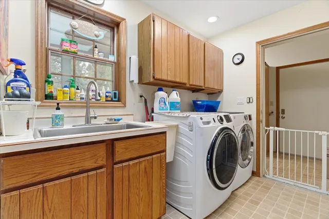 a utility room with sink dryer and washer