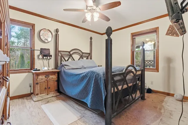 a bedroom with a bed and a chandelier