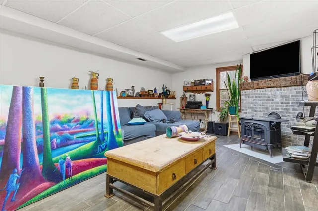 a living room with furniture flat screen tv and a fireplace