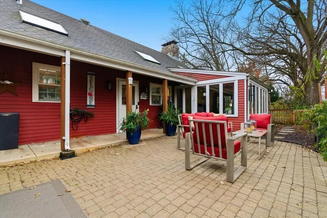 a view of a chair and tables in the patio
