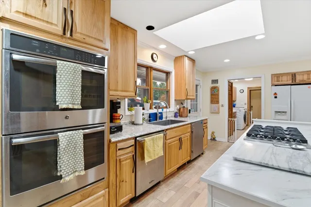 a kitchen with stainless steel appliances kitchen island a stove and a refrigerator