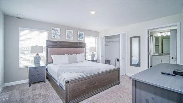 a bathroom with a granite countertop sink a mirror and a bathtub