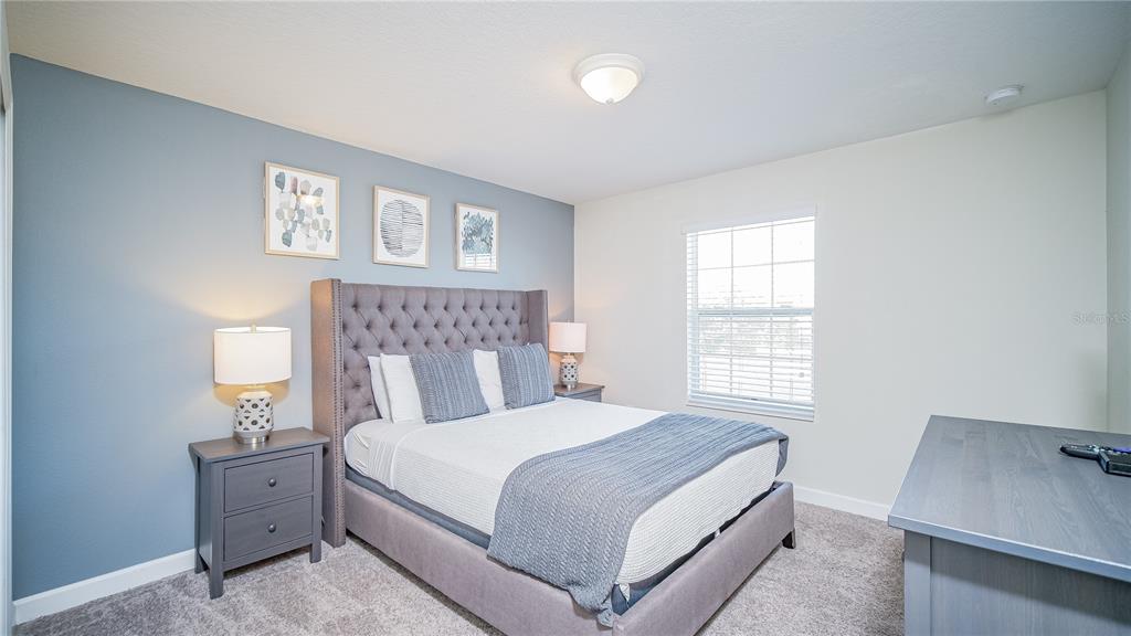 8919 Stinger Drive Davenport, FL 33896 - Photo 18 of 39 a bedroom with a bed and a window