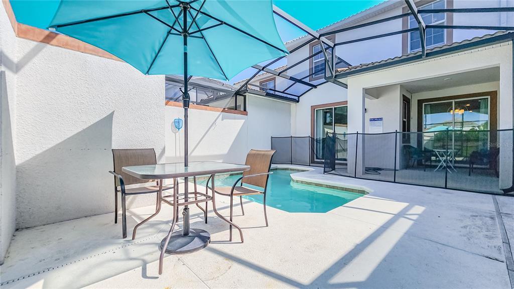 8919 Stinger Drive Davenport, FL 33896 - Photo 22 of 39 a view of a swimming pool with a patio