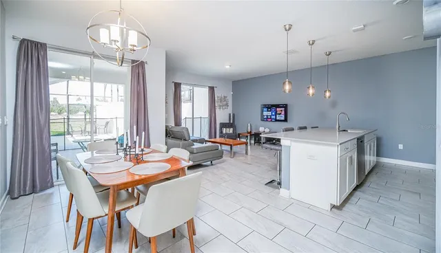 a kitchen with stainless steel appliances kitchen island granite countertop a sink refrigerator and microwave