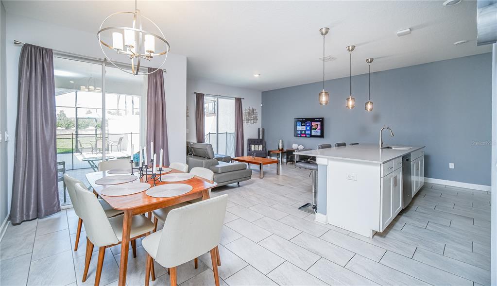 8919 Stinger Drive Davenport, FL 33896 - Photo 8 of 39 a outdoor dining space with furniture and a chandelier