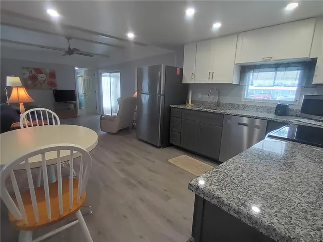 a white toilet sitting next to a small sink