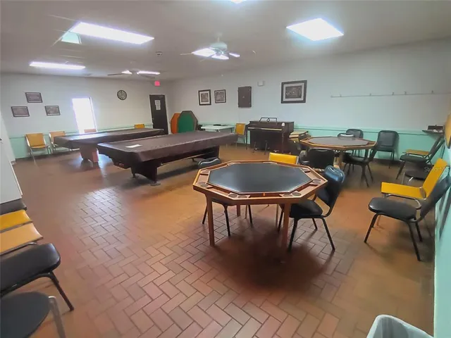 a front view of a house with a yard and palm trees