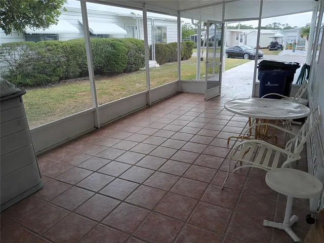 a kitchen with granite countertop stainless steel appliances a refrigerator a stove a sink a dining table and chairs