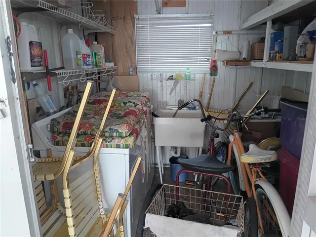 a kitchen with a sink a stove a refrigerator and cabinets