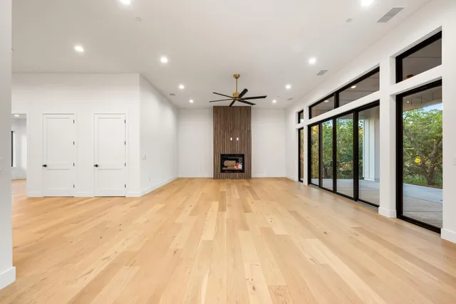 a view of an empty room with a fireplace and a window