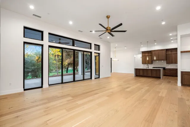 a big room with wooden floor and windows