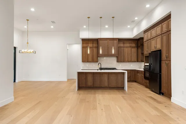 a large kitchen with stainless steel appliances kitchen island granite countertop a large counter top and stove