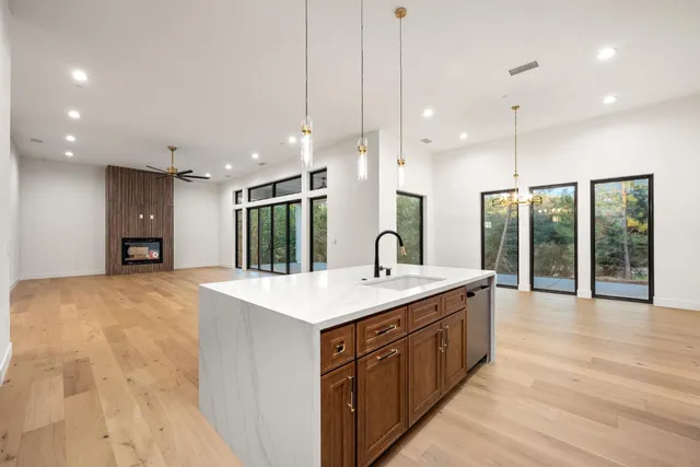 a large kitchen with kitchen island a sink appliances and a large window