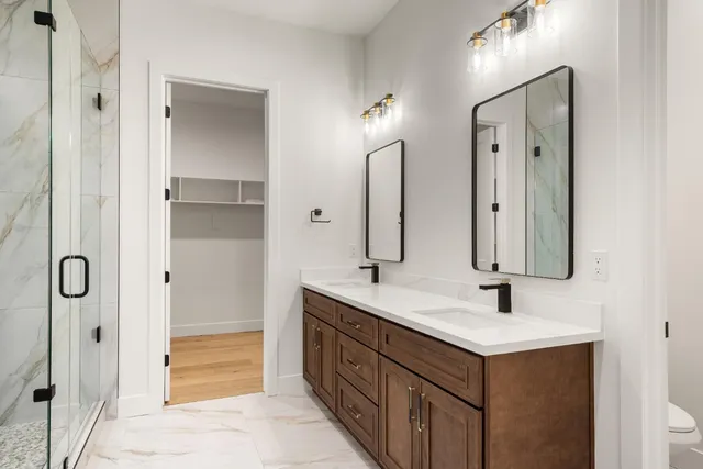 a bathroom with double vanity sink and mirror