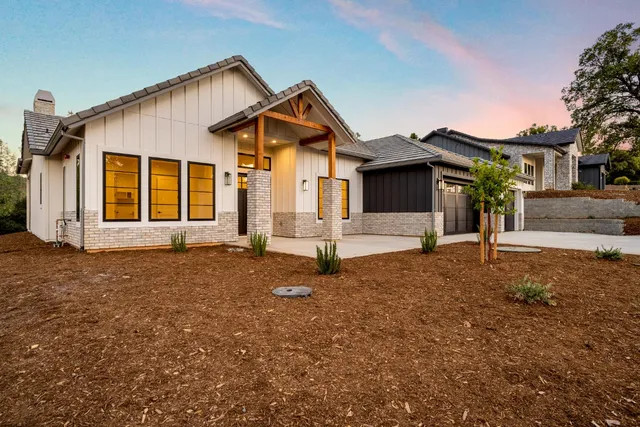 a front view of a house with a garden