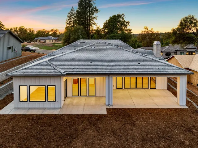 a view of a street with a large barn