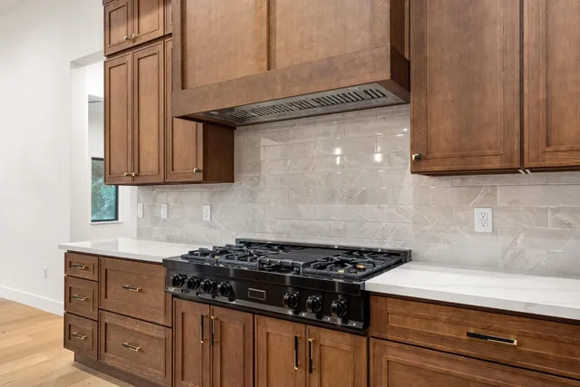 a kitchen with granite countertop stainless steel appliances and cabinets
