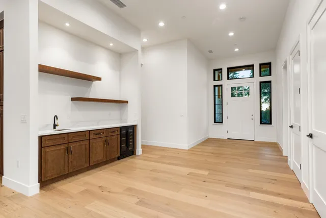 a large kitchen with kitchen island a sink stainless steel appliances and cabinets