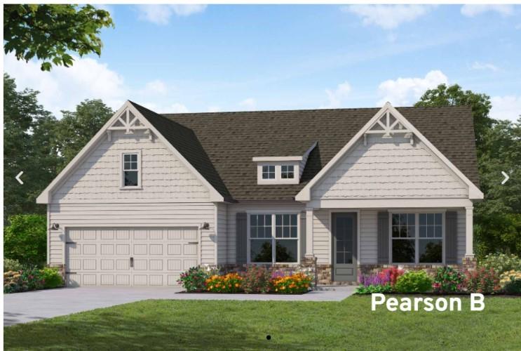 a front view of a house with a garden and plants