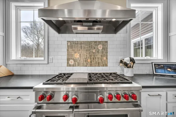 a stove top oven sitting inside of a kitchen