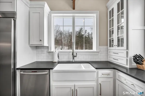 a view of a kitchen sink and a window