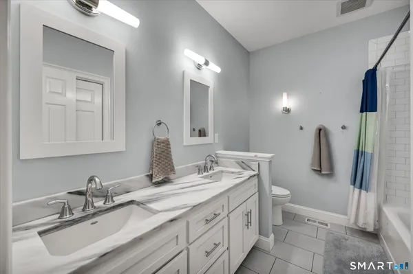 a kitchen with stainless steel appliances granite countertop a sink a stove and cabinets