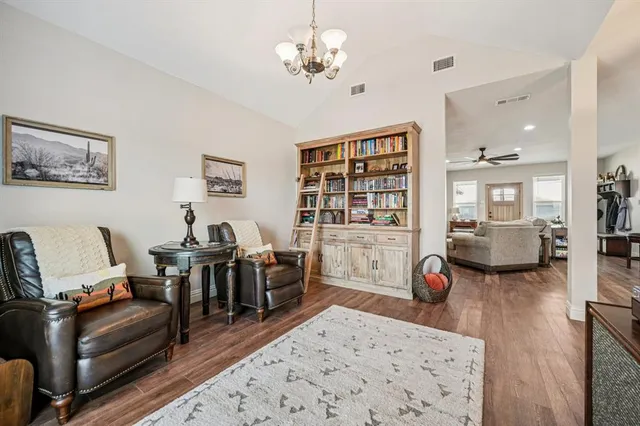 a living room with furniture flat screen tv and couches